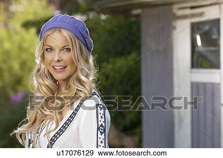 Stock Photo - Smiling woman standing outside. Fotosearch