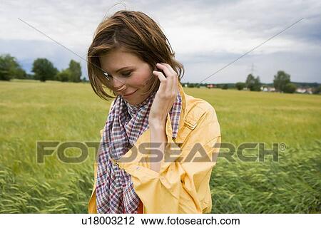 Smiling woman walking in tall grass View Large Photo Image Stock Image - Smiling woman walking in tall grass. Fotosearch