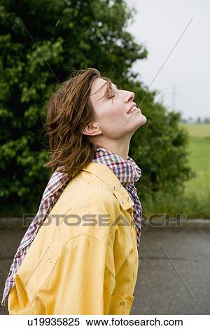 Stock Photography - Smiling woman walking on rural road. Fotosearch
