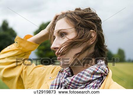 Stock Image - Smiling woman walking outdoors. Fotosearch