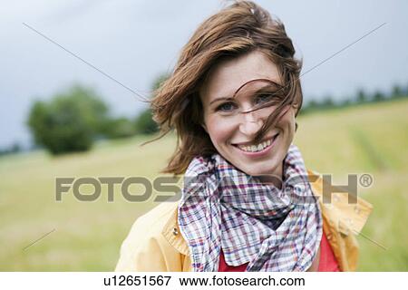 Stock Photo - Smiling woman walking outdoors. Fotosearch