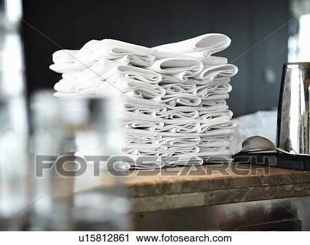 Stock Image - Stack of folded napkins in kitchen. Fotosearch