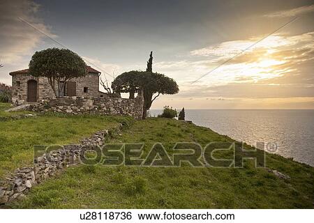 Stone house overlooking coastline View Large Photo Image Stock Photograph - Stone house overlooking coastline. Fotosearch