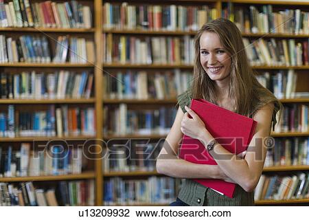 Student carrying binder in library View Large Photo Image Stock Image - Student carrying binder in library. Fotosearch