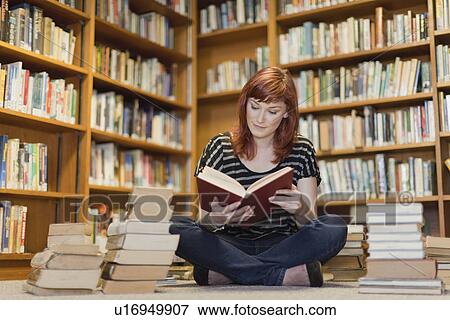 Student in pile of books in library View Large Photo Image Stock Photo - Student in pile of books in library. Fotosearch