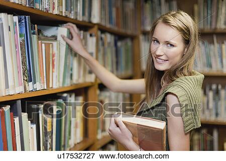 Student selecting books in library View Large Photo Image Stock Photo - Student selecting books in library. Fotosearch