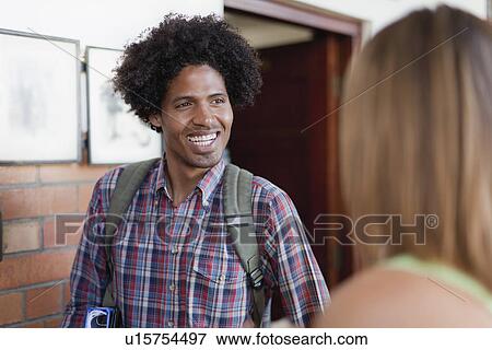 Stock Photo - Student smiling in hallway. Fotosearch