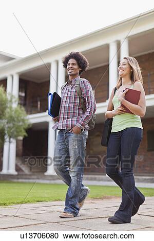Students laughing together on campus View Large Photo Image Stock Image - Students laughing together on campus. Fotosearch
