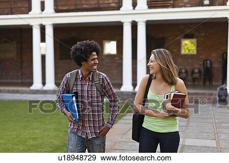 Stock Photo - Students laughing together on campus. Fotosearch