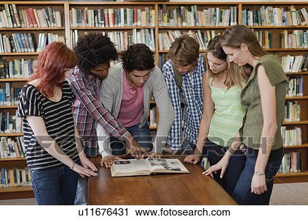 Students reading book in library View Large Photo Image Stock Image - Students reading book in library. Fotosearch