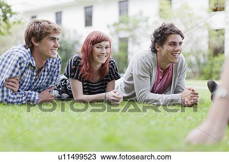 Students relaxing on grass on campus View Large Photo Image Stock Image - Students relaxing on grass on campus. Fotosearch
