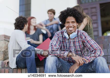 Students sitting together on campus View Large Photo Image Stock Image - Students sitting together on campus. Fotosearch