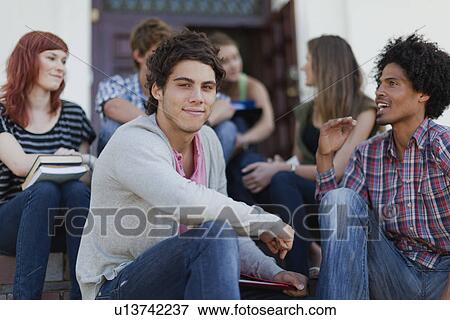 Students sitting together on campus View Large Photo Image Stock Photo - Students sitting together on campus. Fotosearch