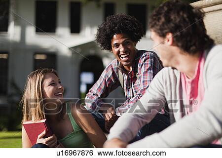 Students sitting together on campus View Large Photo Image Stock Photograph - Students sitting together on campus. Fotosearch