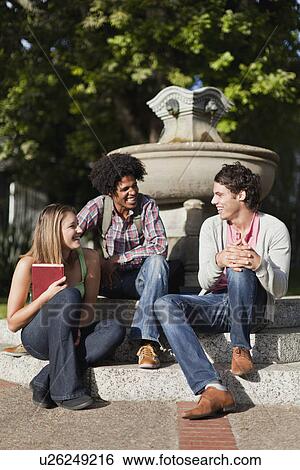 Students sitting together on campus View Large Photo Image Stock Photograph - Students sitting together on campus. Fotosearch