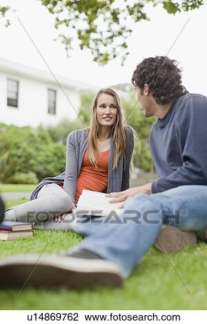 Students studying on grass on campus View Large Photo Image Stock Image - Students studying on grass on campus. Fotosearch