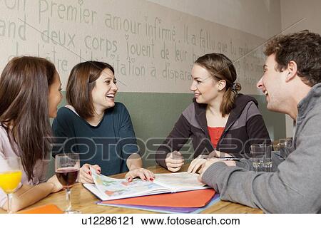 Students studying together in cafe View Large Photo Image Stock Image - Students studying together in cafe. Fotosearch