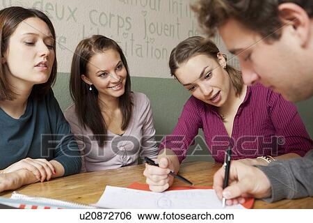 Stock Photograph - Students studying together in cafe. Fotosearch