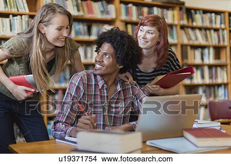 Students studying together in library View Large Photo Image Picture - Students studying together in library. Fotosearch