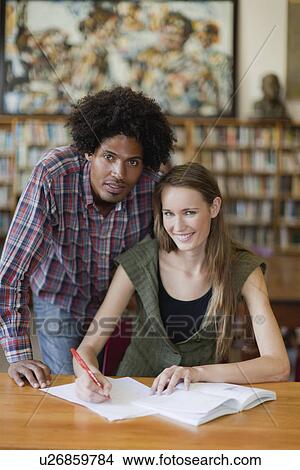 Students studying together in library View Large Photo Image Picture - Students studying together in library. Fotosearch