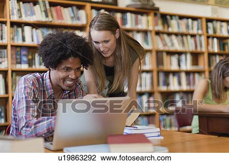 Students studying together in library View Large Photo Image Stock Image - Students studying together in library. Fotosearch