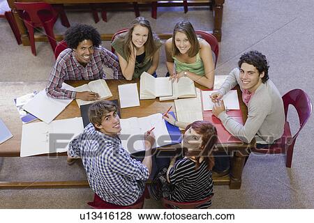 Students studying together in library View Large Photo Image Stock Photo - Students studying together in library. Fotosearch