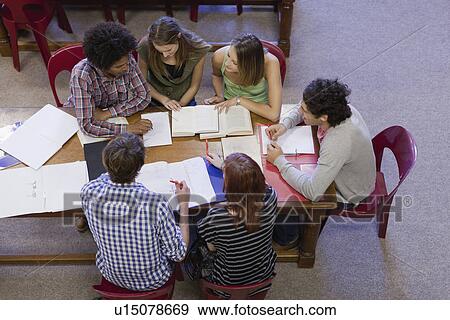 Stock Photo - Students studying together in library. Fotosearch