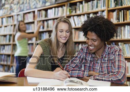 Students studying together in library View Large Photo Image Stock Photograph - Students studying together in library. Fotosearch