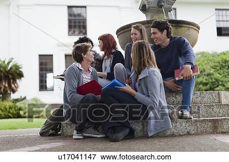 Students talking on fountain on campus View Large Photo Image Stock Photo - Students talking on fountain on campus. Fotosearch
