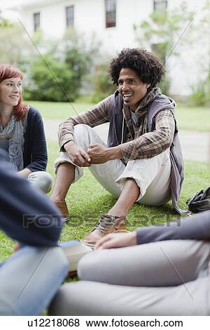 Students talking on grass on campus View Large Photo Image Stock Photo - Students talking on grass on campus. Fotosearch