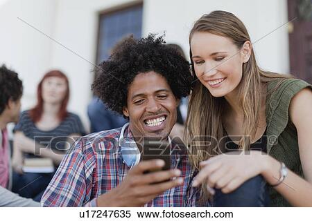 Students using cell phone on campus View Large Photo Image Stock Photography - Students using cell phone on campus. Fotosearch