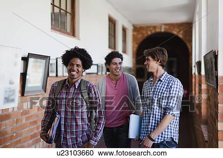 Students walking together in hallway View Large Photo Image Stock Image - Students walking together in hallway. Fotosearch