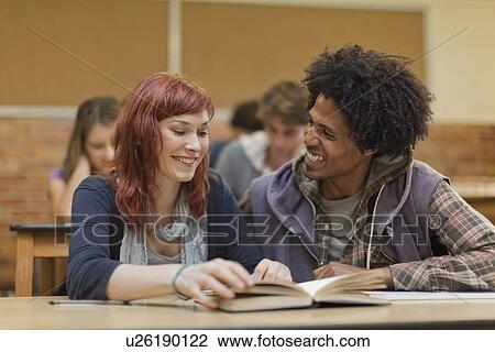 Stock Image - Students working together in class. Fotosearch