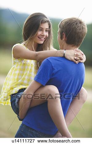 Stock Photo - Teenage couple hugging outdoors. Fotosearch