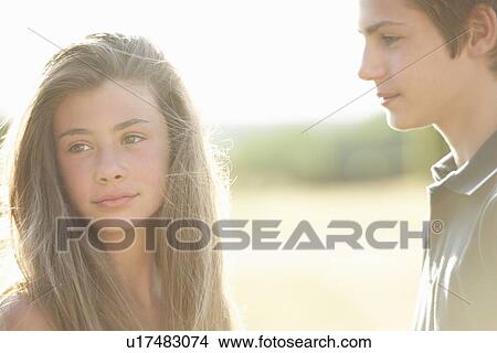 Teenage couple standing outdoors View Large Photo Image Picture - Teenage couple standing outdoors. Fotosearch