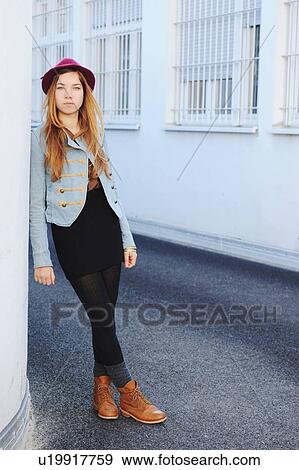 Stock Photo - Teenage girl leaning on wall outdoors. Fotosearch
