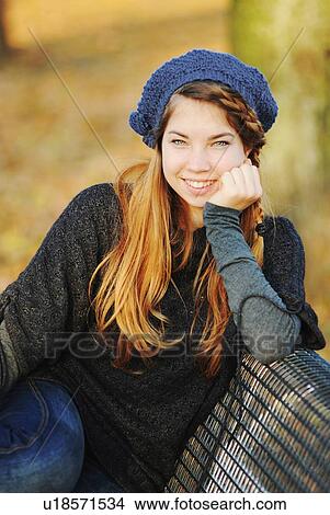 Teenage girl sitting on park bench View Large Photo Image Picture - Teenage girl sitting on park bench. Fotosearch