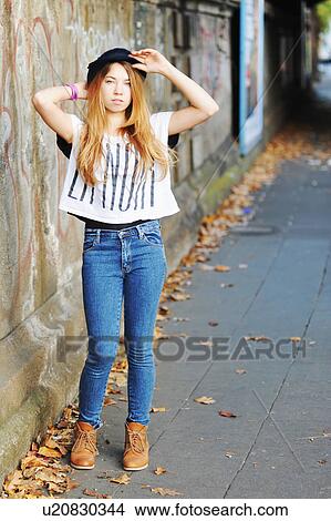 Teenage girl standing on urban street View Large Photo Image Picture - Teenage girl standing on urban street. Fotosearch