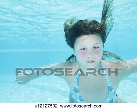 Stock Image - Teenage girl swimming in tropical ocean. Fotosearch