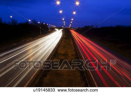 Stock Image - Time-lapse view of traffic at night. Fotosearch