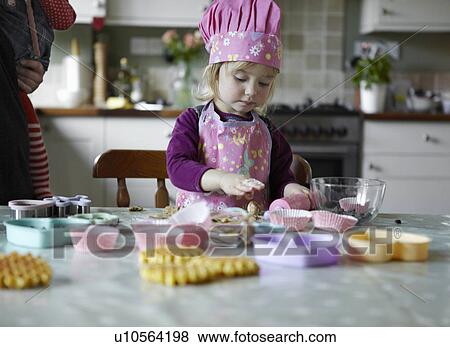 Toddler girl baking in kitchen View Large Photo Image Stock Photo - Toddler girl baking in kitchen. Fotosearch