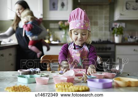 Toddler girl baking in kitchen View Large Photo Image Stock Photo - Toddler girl baking in kitchen. Fotosearch