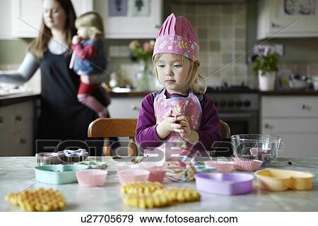 Toddler girl baking in kitchen View Large Photo Image Stock Photo - Toddler girl baking in kitchen. Fotosearch