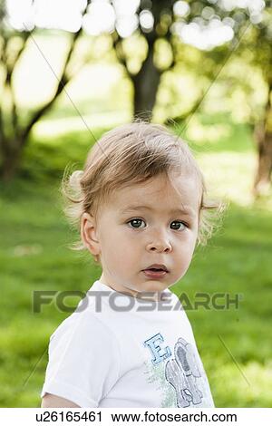 Toddler standing in park View Large Photo Image Stock Image - Toddler standing in park. Fotosearch
