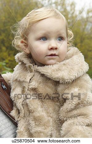 Toddler wearing fuzzy coat outdoors View Large Photo Image Picture - Toddler wearing fuzzy coat outdoors. Fotosearch