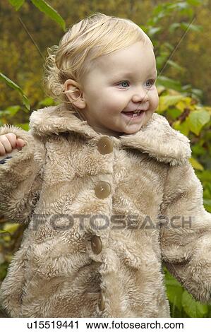 Toddler wearing fuzzy coat outdoors View Large Photo Image Stock Image - Toddler wearing fuzzy coat outdoors. Fotosearch