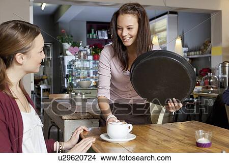 Waitress serving woman in cafe View Large Photo Image Picture - Waitress serving woman in cafe. Fotosearch