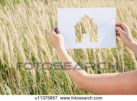 Woman holding paper house cut out View Large Photo Image Stock Photo - Woman holding paper house cut out. Fotosearch
