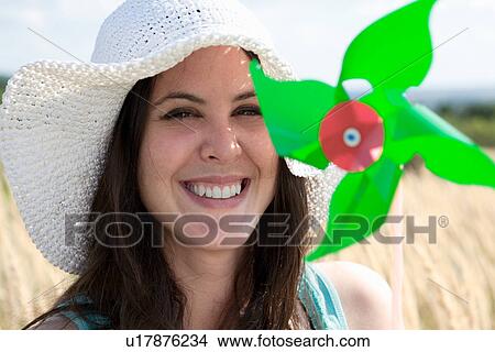 Woman holding pinwheel in wheatfield View Large Photo Image Picture - Woman holding pinwheel in wheatfield. Fotosearch