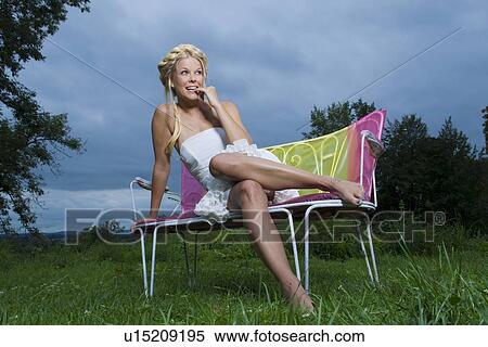 Woman in gown sitting on park bench View Large Photo Image Stock Photography - Woman in gown sitting on park bench. Fotosearch